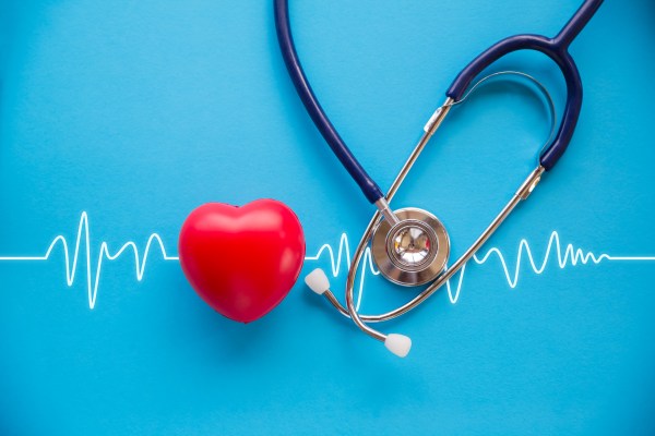 Encouraging Heart Healthy Choices in the Workplace stethoscope and red heart with cardiogram